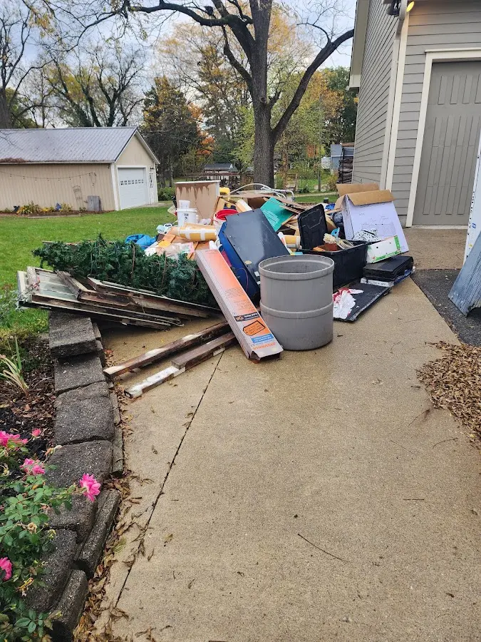 Dumpster being loaded with debris for Estate Cleanout Dumpster Rental in St. Louis